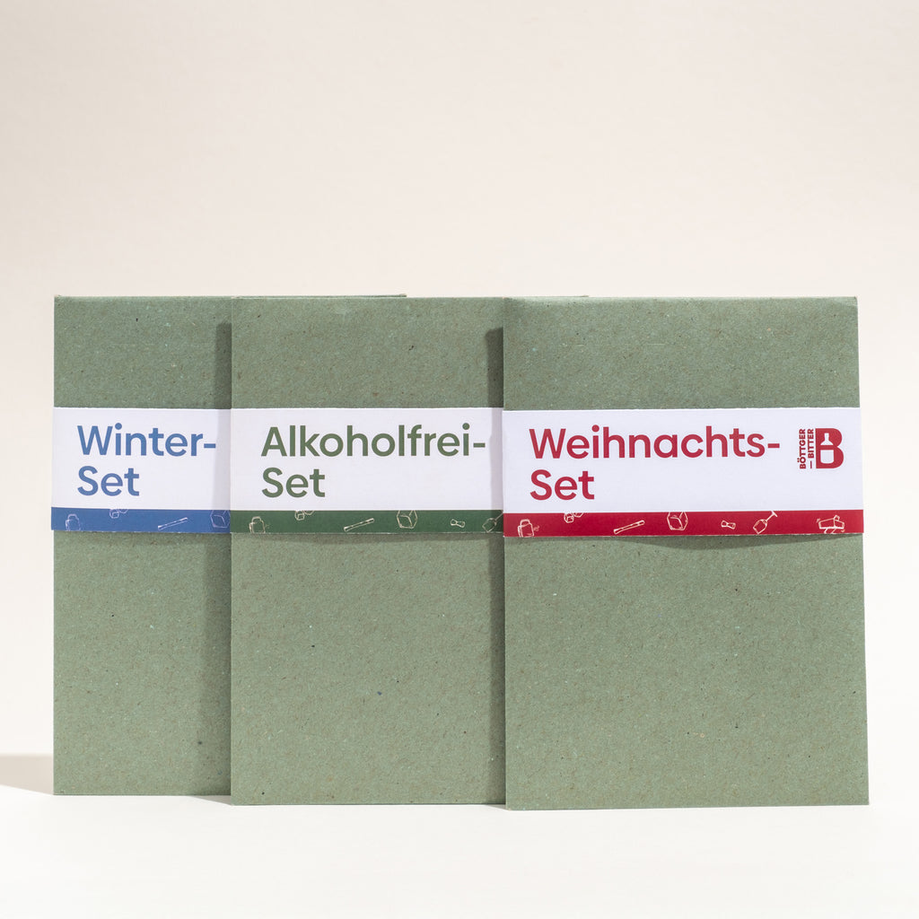 Drei grüne Geschenkpackungen nebeneinander: Winter-Set, Alkoholfrei-Set und Weihnachts-Set.